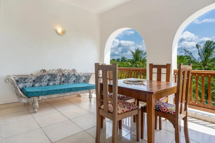 Private balcony dining area with tropical views at Tulia